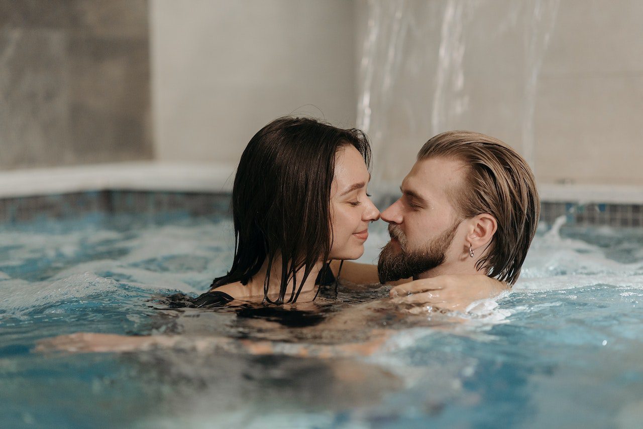 Un couple s'embrassant dans une piscine